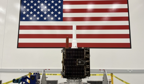 Image of ARGOS-4 in front of the American flag.