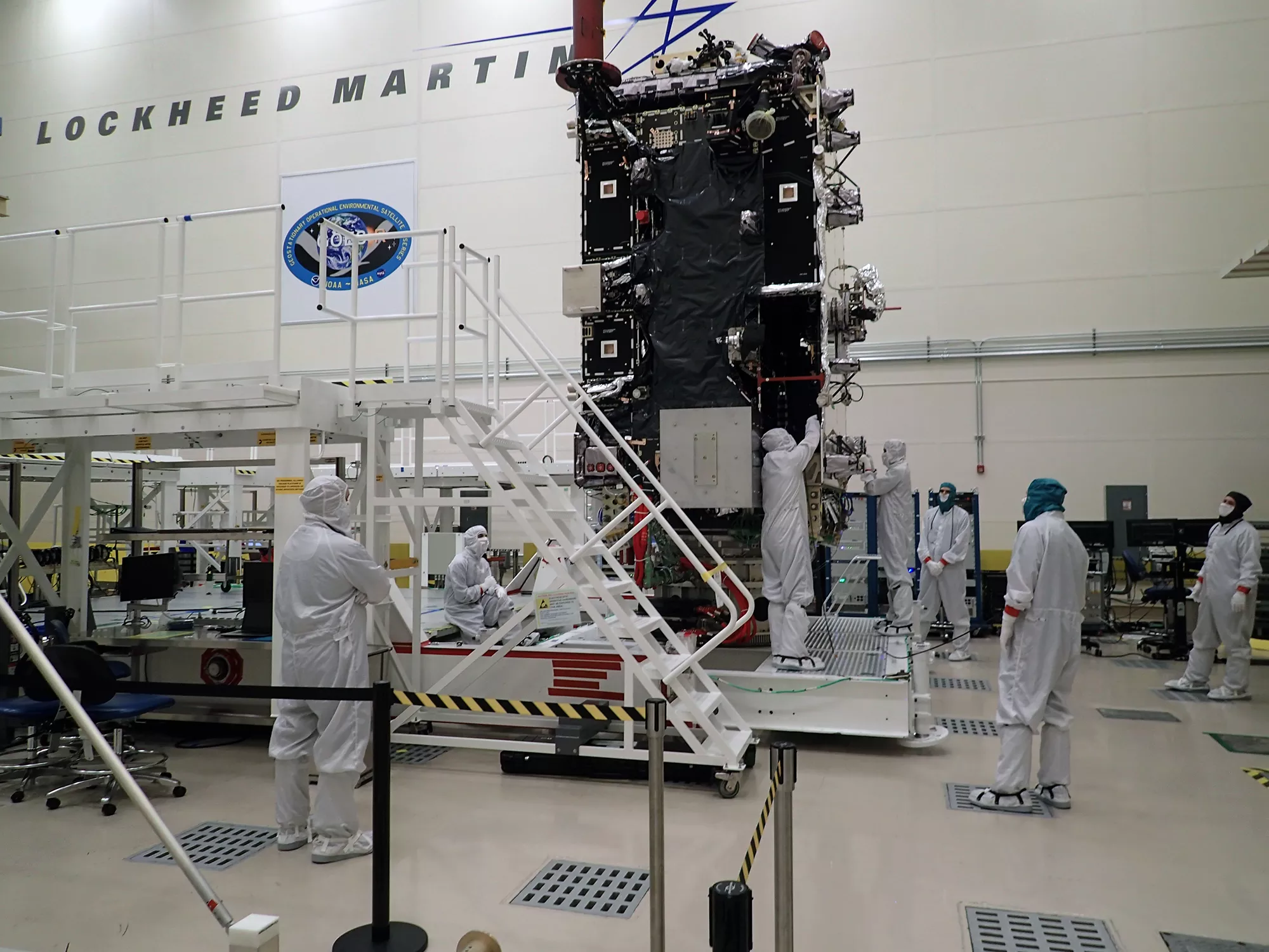 IMage of Technicians work on GOES-T in a clean room at Lockheed Martin in Littleton, Colorado. Credit: Lockheed Martin