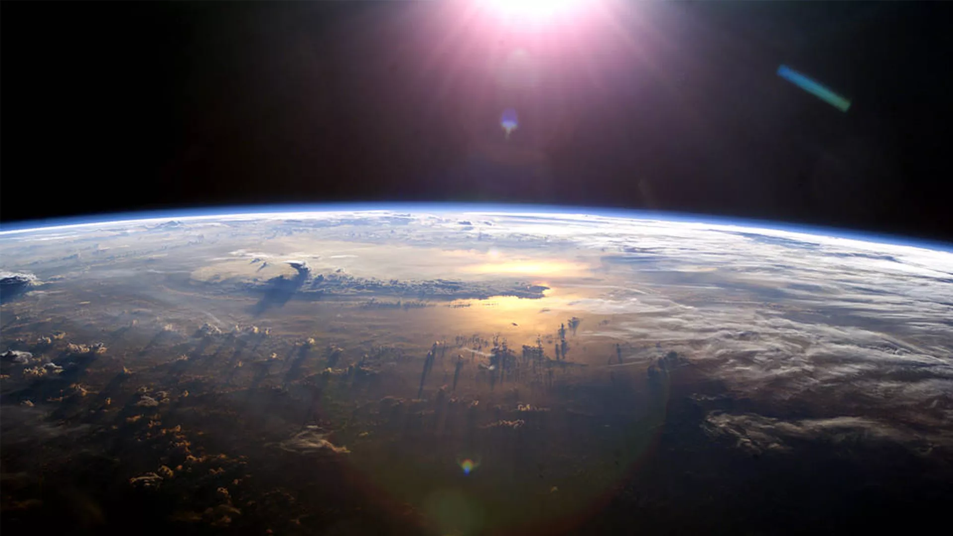 Image of the earth with the sun in the background