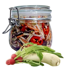 A jar with colorful shreds of vegetables and raw radishes