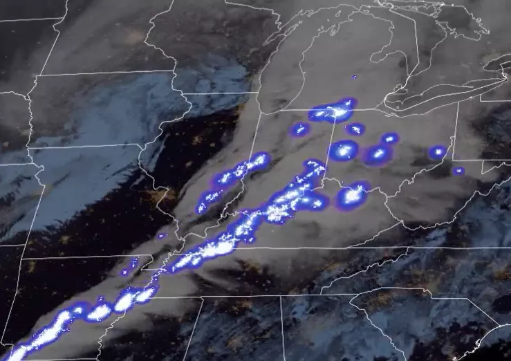 Large gray storm cloud centered over the Midwest includes blue white areas that represent lighting activity within the storm. 
