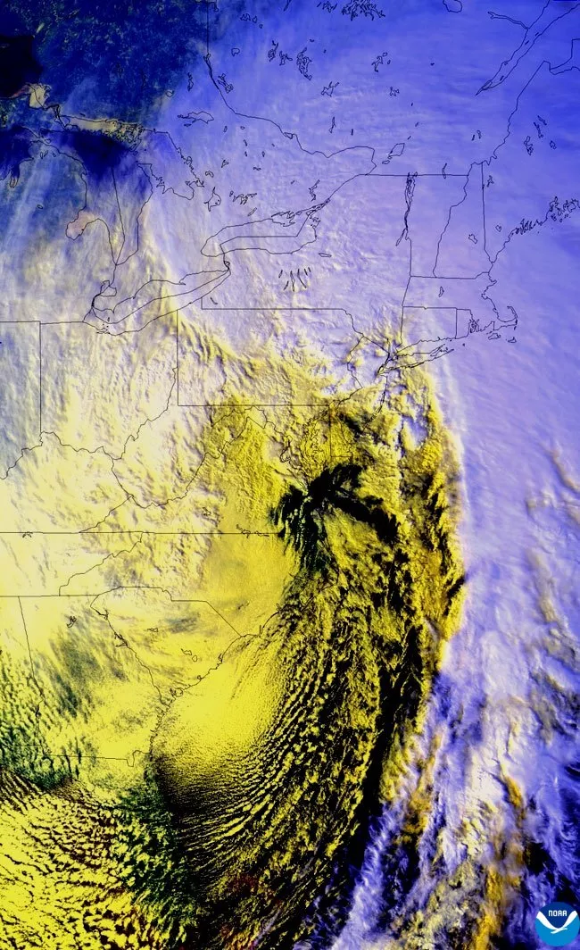 An Advanced Very High Resolution Radiometer (AVHRR) image from the polar-orbiting NOAA-12 satellite on March 13, 1993, showing the storm still pounding parts of the eastern U.S. with snow, high winds and coastal flooding.