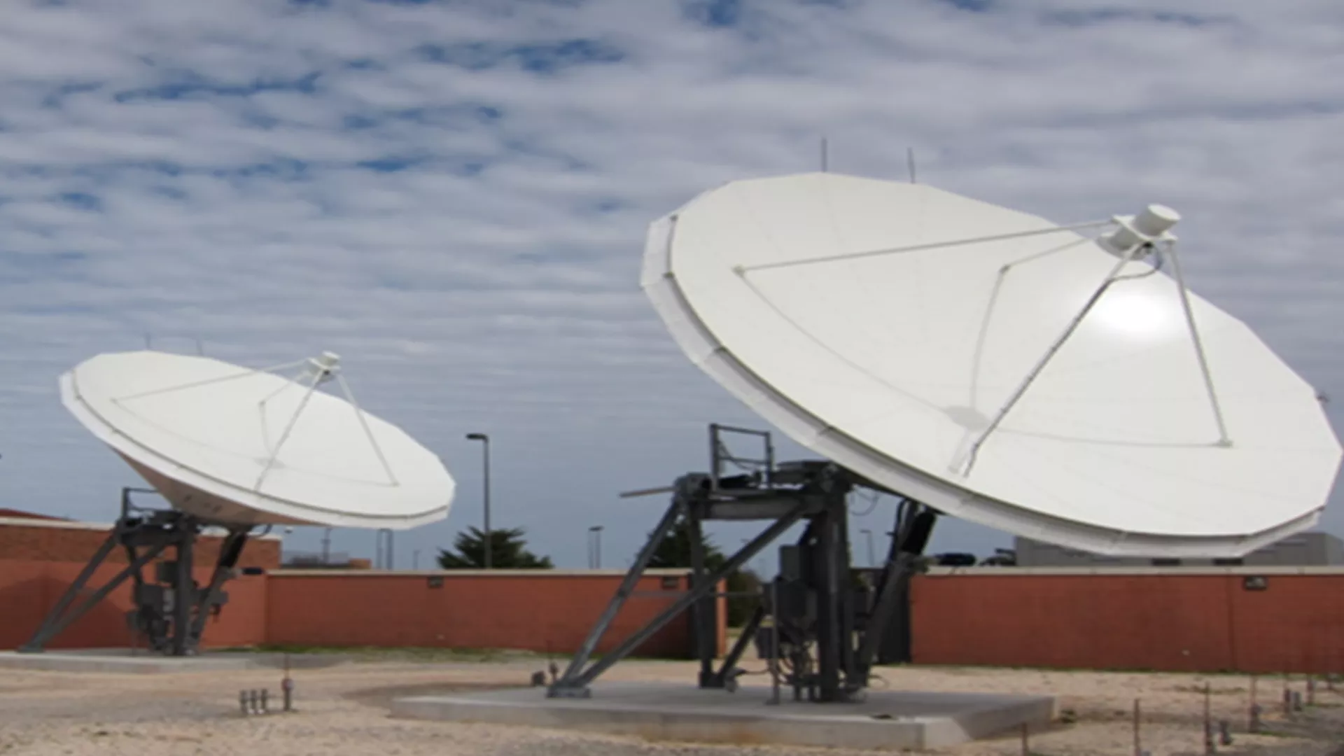 Image of a satellite dishes on top of a building.