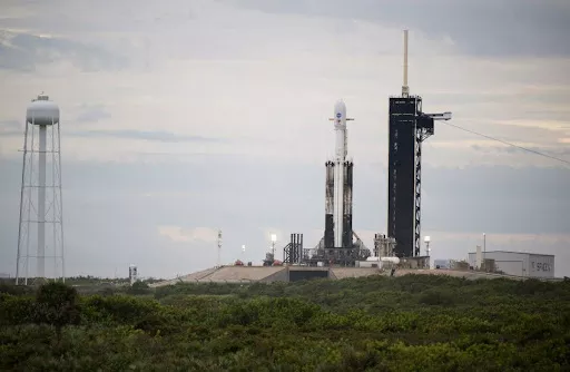 Image of goes-t on the launch pad with a rocket.