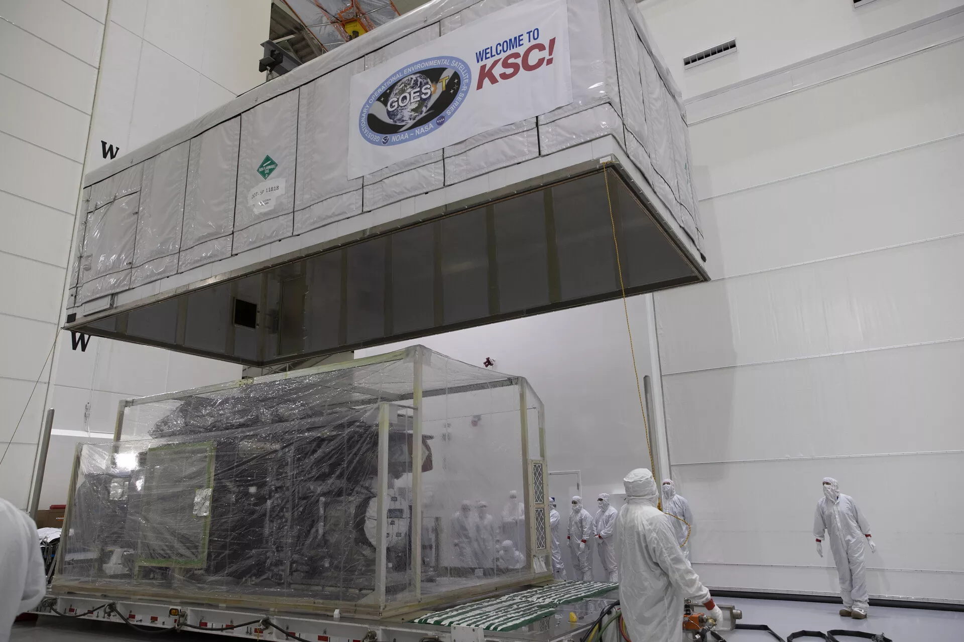 Image of a large box the size of bus containing the GOES-T satellite.