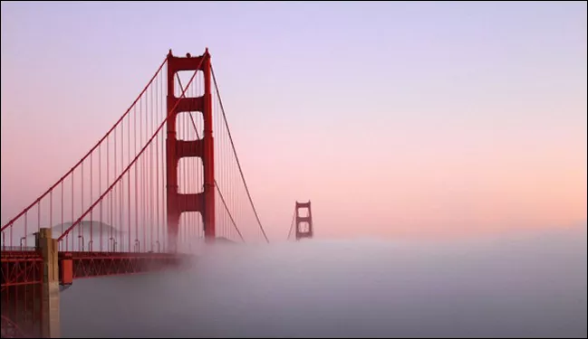 Image of Golden Gate bridge in San Francisco, along with sunset and fog.
