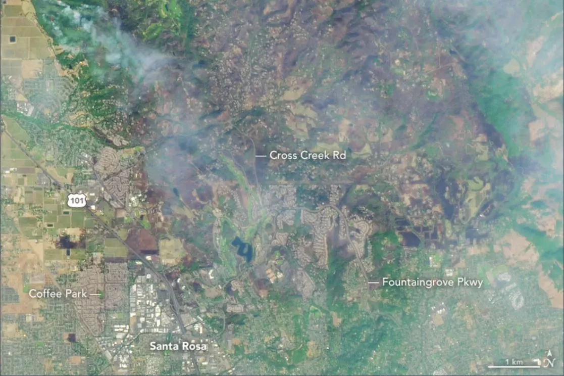 A satellite image of Northern California showing smoke and wildfires, including a heavily burned area between Santa Rosa and Calistoga